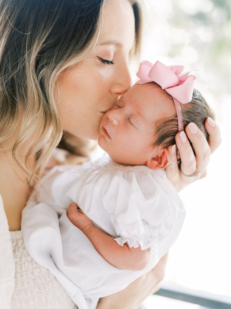 mom kissing baby